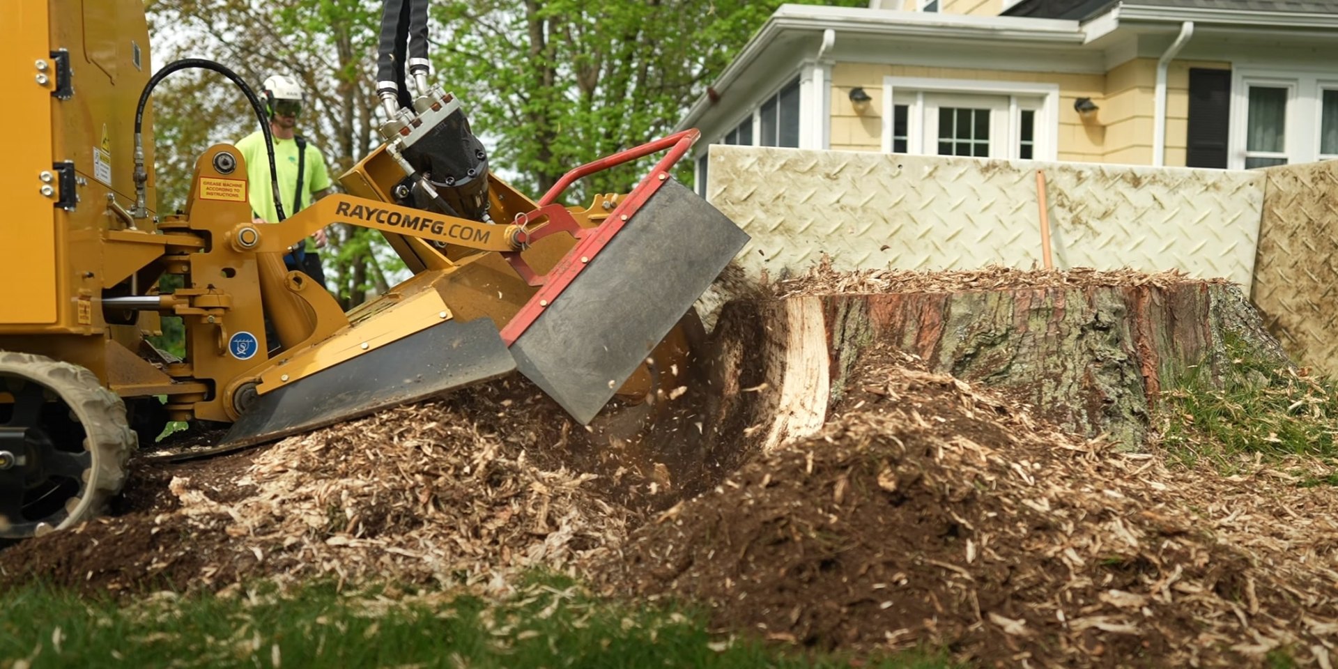 Professional Stump Removal - Residential Tree Services Heavy duty stump grinder machine removing large tree stump in residential backyard